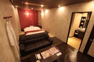 a small room with a bed and a chair at Hotel Shindbad Aomori -Love Hotel- in Aomori