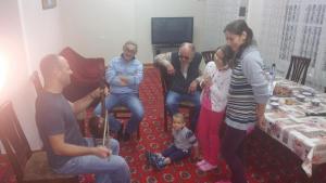 a group of people standing in a living room at Gulnara Guesthouse - Hostel in Tashkent