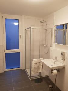 a white bathroom with a shower and a sink at AB Apartment Kornwestheim in Kornwestheim