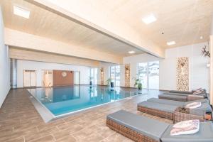 a large swimming pool in a large room at Embacher Sporthotel in Embach