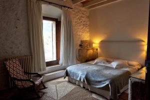 a bedroom with a bed and a window at Mirabó de Valldemossa in Valldemossa