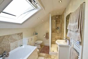 a bathroom with a tub and a toilet and a sink at Endearing Edwardian House in Quaint Deal, Kent in Deal