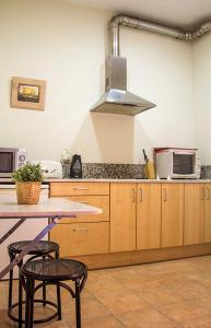 a kitchen with a table with two chairs and a microwave at Gaudi Apartment 2 in Barcelona