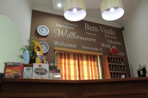 a counter with a wall with signs on it at Real Caparica Hotel in Costa da Caparica