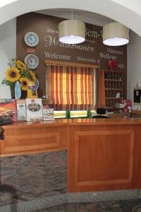a cashier counter in a store with a sign at Real Caparica Hotel in Costa da Caparica