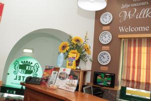 a room with clocks on the wall and a desk at Real Caparica Hotel in Costa da Caparica
