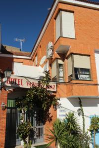 a building with a sign on the side of it at Hotel Vazquez Diaz in Nerva