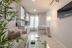 a living room with a couch and a table at Apartamentos Recogidas in Granada