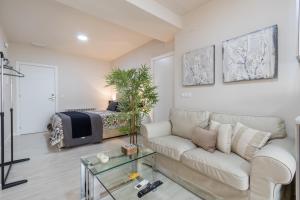 a living room with a couch and a bed at Apartamentos Recogidas in Granada