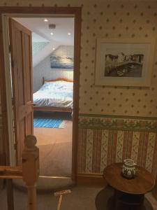 a bedroom with a door leading to a bed at Chaseborough farm in Wimborne Minster