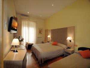Postel nebo postele na pokoji v ubytování Hotel Alexander & Spa
