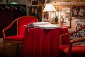 a table with a red table cloth and a laptop on it at Hotel Krona Domžale in Domžale