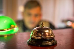 a bell sitting on top of a wooden table at Hotel Krona Domžale in Domžale