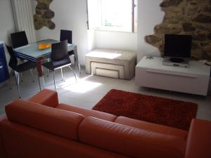 a living room with a couch and a table at Sea view apartment 10 minute walk to the sea in San Vito Chietino