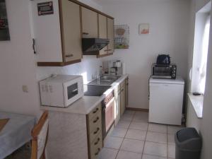 a small kitchen with a sink and a microwave at Haus Alexander in Mechernich