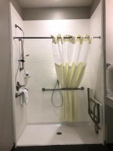 a shower with a curtain in a bathroom at Best Western Plus Tech Medical Center Inn in Lubbock