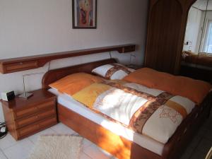 a bedroom with two twin beds and a night stand at Haus Alexander in Mechernich