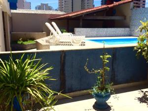 a pool on top of a building with plants at Hotel Marlin Azul in Vila Velha