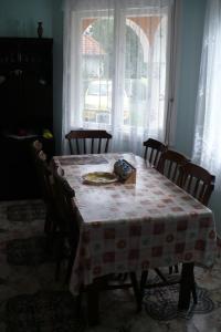 a dining room table with a plate of food on it at Árvácska Nyaraló in Balatonmáriafürdő