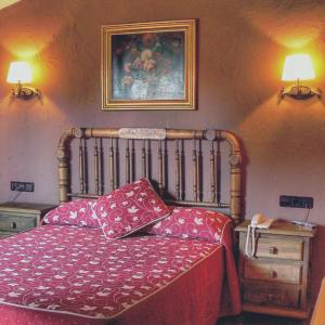 a bedroom with a bed with two pillows on it at Hotel Caseta Nova in Castalla
