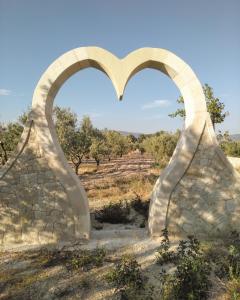 an arch in a stone wall in a field at Hotel Caseta Nova in Castalla