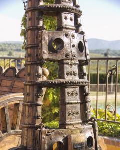 a metal bird feeder sitting next to a bench at Hotel Caseta Nova in Castalla