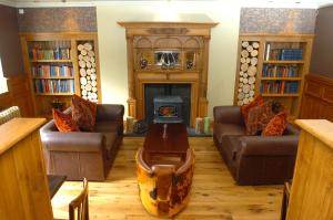 a living room with a wood stove in the middle at The Bear's Paw in Warmingham