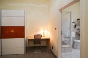 a small desk in a bathroom with a toilet at Hotel Margrit in Berlin +100 photos