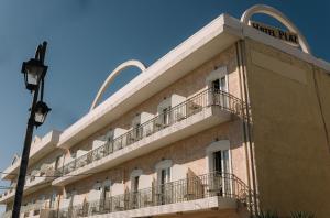 a building with a sign that reads hotel run at Plaz Hotel in Selianitika