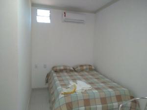 a small room with a bed with a banana on it at Pousada beira rio in Baía da Traição