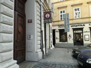 alejka z zegarem na boku budynku w obiekcie Tiva Downtown Apartments w Pradze