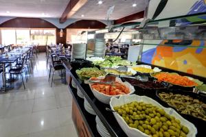 a buffet line with many different types of food at Apartamentos Marina d'Or Beach 2ª Linea in Oropesa del Mar