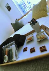 a tray with chocolates and other items on a bed at Castle Terrace (B3 R2) in Tipton +15 photos