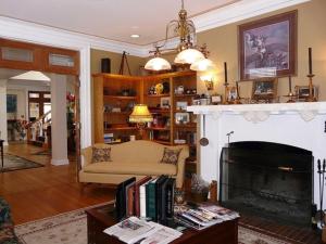 a living room with a couch and a fireplace at Lilac Inn in Brandon