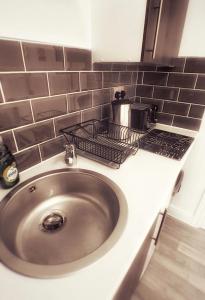 a sink with a toaster on top of a counter at Castle Terrace (B3 R2) in Tipton