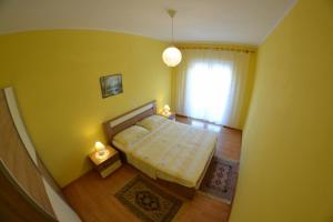 a small bedroom with a bed and a window at Sloth in Rab