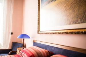 a bedroom with a bed and a painting on the wall at Amarcord casa vacanze in Alberobello