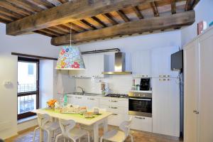 a kitchen with a table and chairs in a room at Agriturismo La Peonia in Bagnoregio