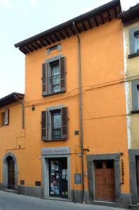 een oranje gebouw met ramen en een winkel bij Agriturismo La Peonia in Bagnoregio