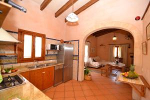 a kitchen with a sink and a refrigerator in a room at Finca Estret 184 by Mallorca Charme in Santa Margalida