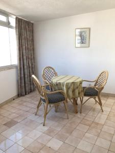 a dining room with a table and chairs at Olinda’s Rooms in Lagos