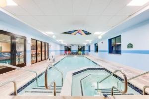a swimming pool in a large room with stairs around it at Wingate by Wyndham - York in York
