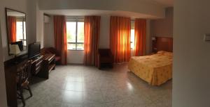 A bed or beds in a room at Hotel Perales