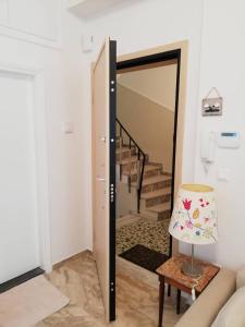 a living room with a door leading to a staircase at Asimelia Luxury Apartment in Heraklio