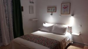 a small bedroom with a bed with white pillows at Asimelia Luxury Apartment in Heraklio