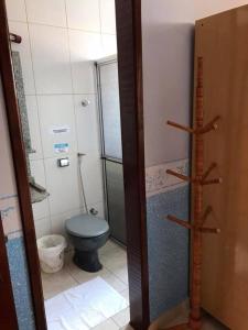 a bathroom with a blue toilet and a shower at Pousada Castelinho in Caldas Novas