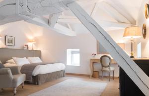 a bedroom with a bed and a desk and a chair at Château de Pierreclos in Pierreclos