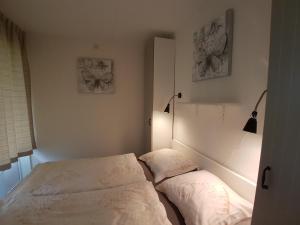 a bedroom with a bed and two pillows at ZAND Bed by the Sea in Westkapelle