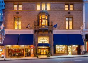 a store front of a brick building with blue awnings at Marines' Memorial Club & Hotel Union Square in San Francisco