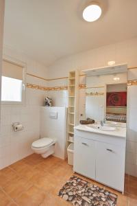 a white bathroom with a toilet and a sink at FranceComfort - L'Aveneau Vieille Vigne in Les Forges